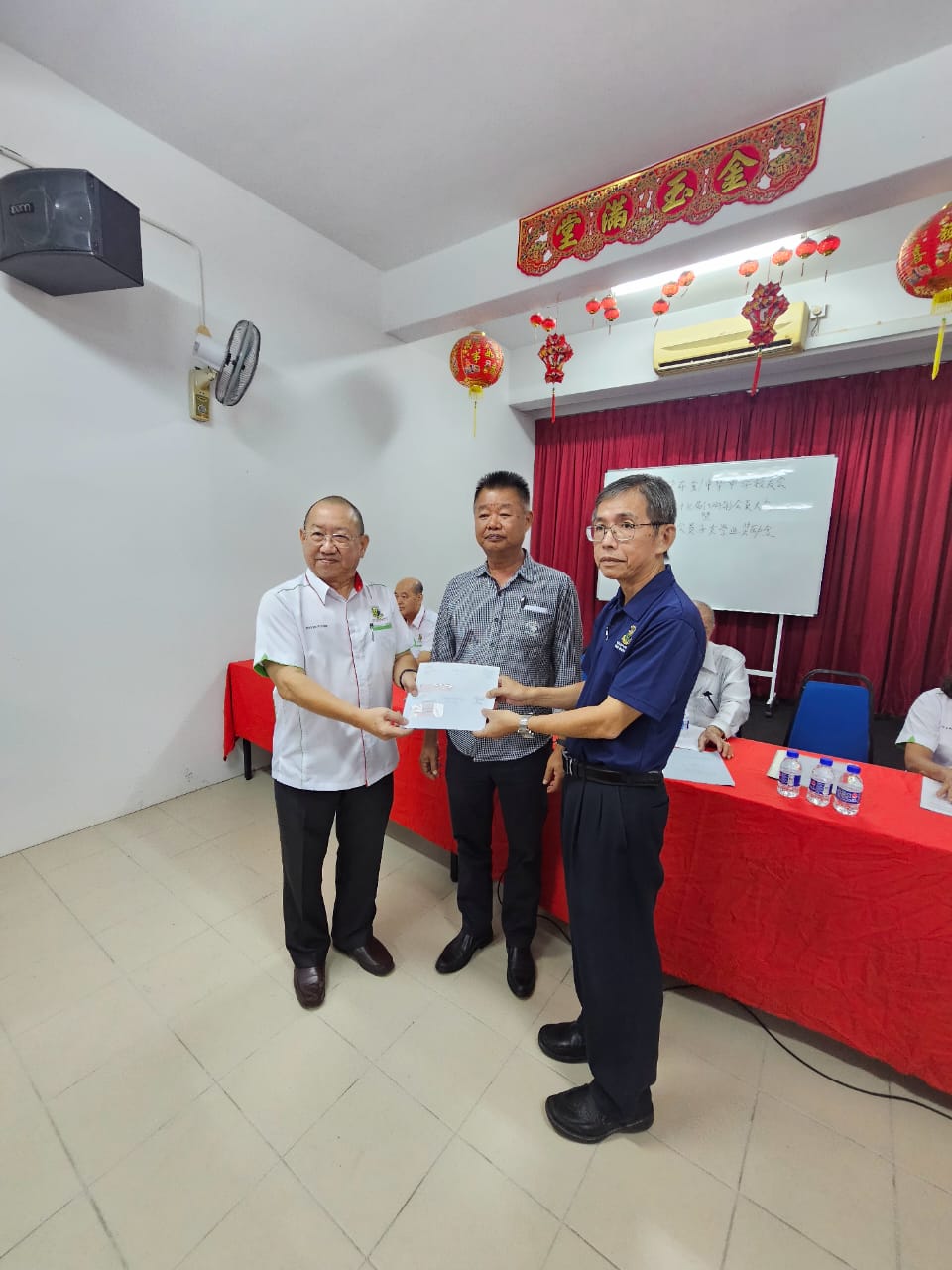 7 本会主席移交支票赞助母校华文协会予铜锣队与母校副校长陈佳强，由董事长拿督蔡永祥见证。